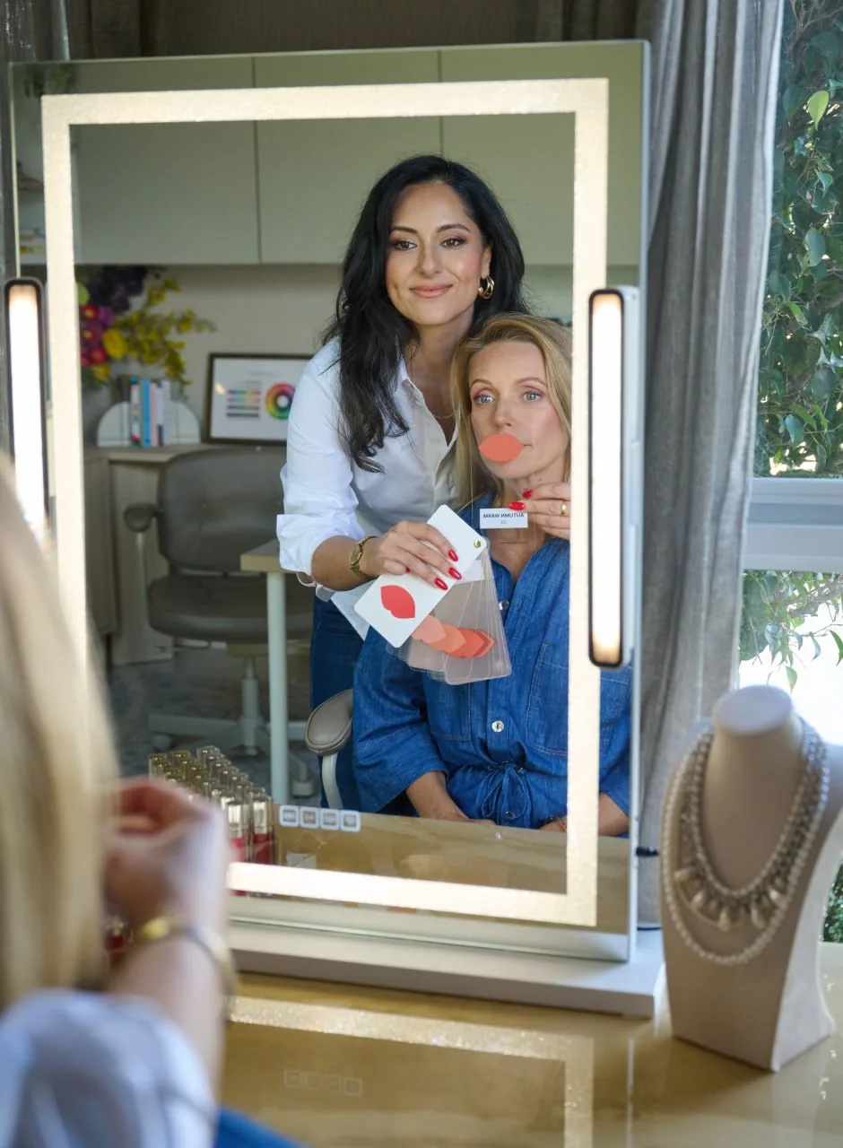 Mina Azarian assessing a client's facial geometry at the mirror in Perth