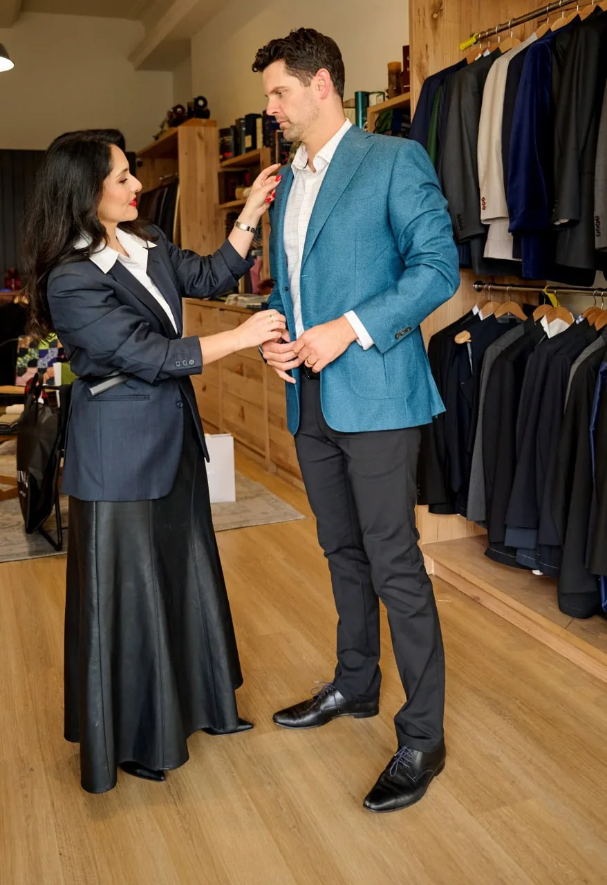 Mina Azarian adjusting a male client's blazer in a Perth menswear fitting